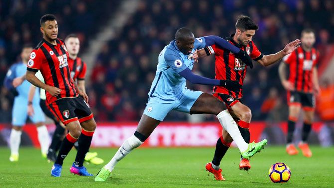 Manchester City's Yaya Toure battles for the ball with Bournemouth's Andrew Surman