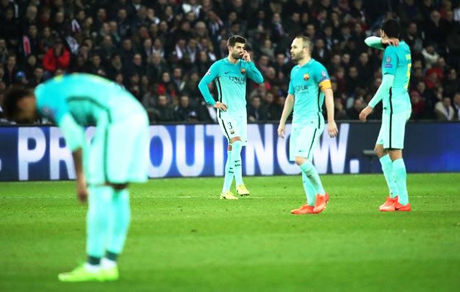 Barcelona's Gerard Pique, Andres Iniesta and Sergio Busquets wear a dejected look after the thrashing at the hands of PSG during their Champions League Last 16 first leg match in Paris on Tuesday