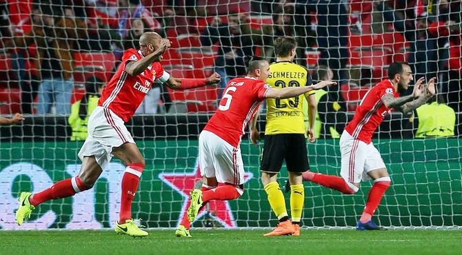 Benfica's Kostas Mitroglou celebrates scoring their first goal against Borussia Dortmund during their UEFA Champions League Round of 16 First Leg match at Estadio da Luz, in Portugal on Tuesday