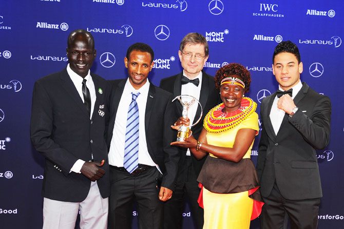 The Winners of the Laureus Sport for Good the Olympic Refugee team pose with their trophy and Laureus Academy Member Tegla Loroupe at the Winners Press Conference and Photocall at the Salle des Etoiles,Sporting Monte Carlo in Monaco on Tuesday