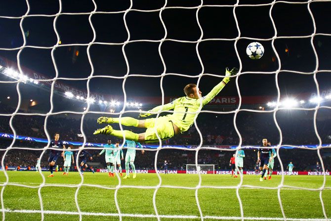 Barcelona keeper Marc-Andre ter Stegen goes airborne as he fails in his attempt to stop Angel Di Maria score his team's third goal