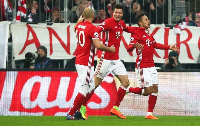Bayern Munich's Thiago Alcantara celebrates scoring their third goal with Robert Lewandowski and Arjen Robben