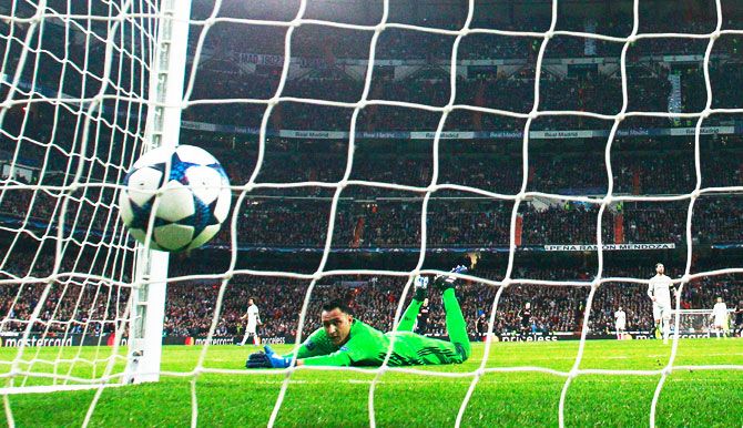 Goalkeeper Keylor Navas of Real Madrid dives in vain as Lorenzo Insigne of Napoli (not pictured) scores their first goal