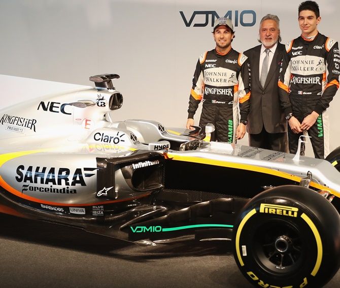 Sergio Perez, left, of Mexico and Sahara Force India, Vijay Mallya, centre, Team Principal and Managing Director and Esteban Ocon of France pose with the VJM10 car