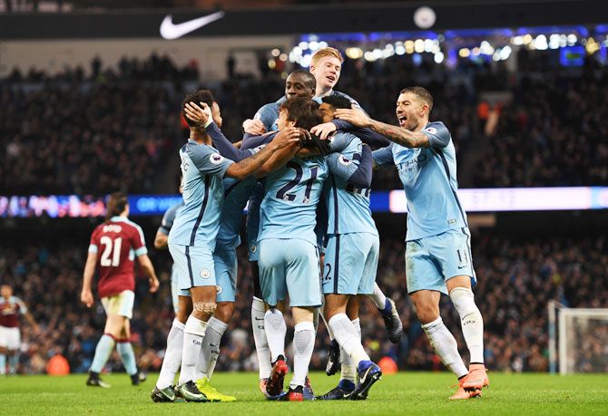 Manchester City's Gael Clichy is mobbed by teammates after scoring the opening goal against Burnley at Etihad Stadium in Manchester