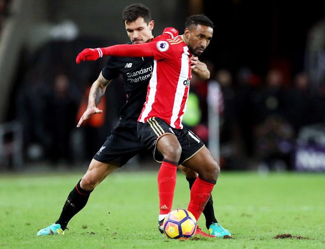 Liverpool's Dejan Lovren (left) and Sunderland's Jermain Defoe (right) battle for the ball during their Premier League match at Stadium of Light in Sunderland on Monday