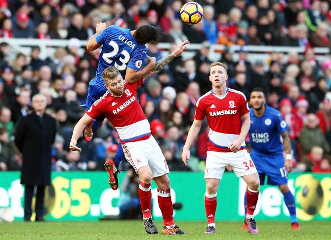 Middlesbrough's Adam Clayton is challenged by an air-borne Leonardo Ulloa of Leicester City during their Premier League match at Riverside Stadium in Middlesbrough on Monday
