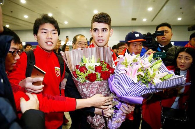 Brazilian international midfielder Oscar is thronged by fans as he arrives at the Shanghai Pudong International Airport, after agreeing to join China super league football club Shanghai SIPG from Chelsea in Shanghai, China, on January 2, 2017