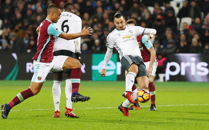 Manchester United's Juan Mata celebrates scoring the opening goal against West Ham United during the Premier League match at London Stadium in Stratford on Monday