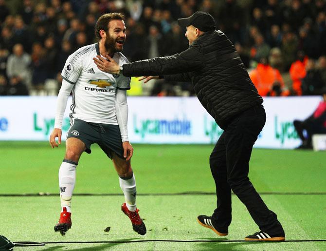 Manchester United's Juan Mata celebrates scoring the opening goal against West Ham United