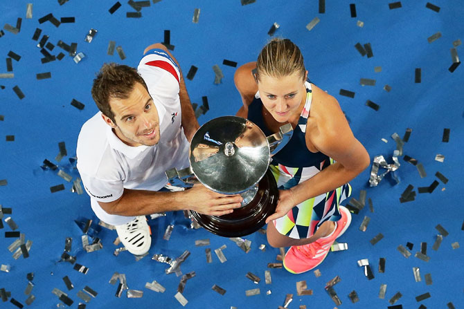 France's Richard Gasquet and Kristina Mladenovic hold the Hopman Trophy after defeating United States' Coco Vandeweghe and Jack Sock in the mixed doubles final of the 2017 Hopman Cup at Perth Arena in Perth on Saturday