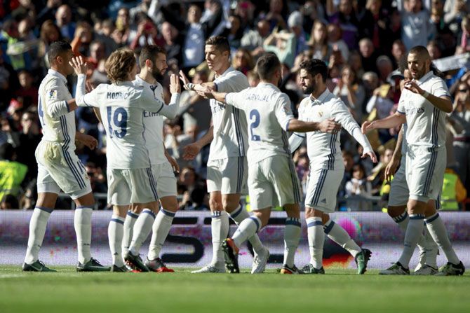 Real Madrid players celebrate after Karim Benzema's goal against Granada CF during their La Liga match at Estadio Santiago Bernabeu on Saturday