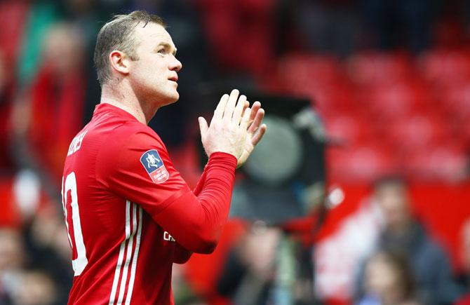 Manchester United's Wayne Rooney applauds supporters following victory over Reading FC in the FA Cup third round match at Old Trafford on Saturday