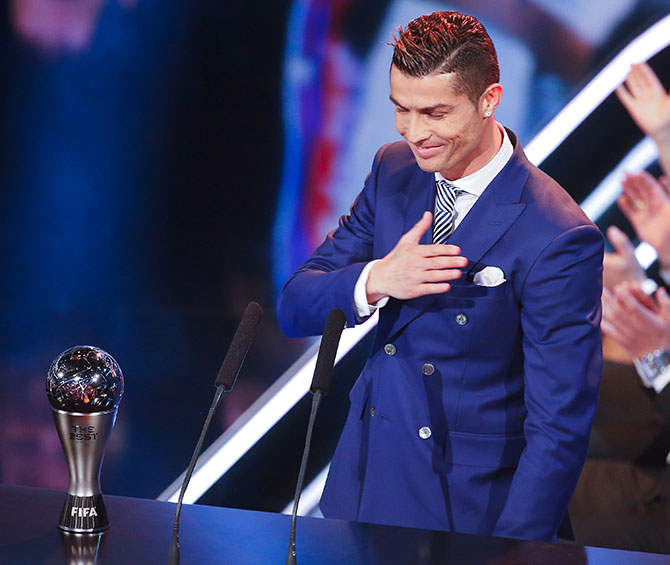 Cristiano Ronaldo celebrates with the trophy. Photograph: Ruben Sprich/Reuters