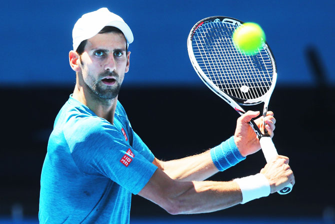 Serbia's Novak Djokovic hits a backhand volley during a practice session on Thursday, ahead of the 2017 Australian Open at Melbourne Park in Melbourne, Australia