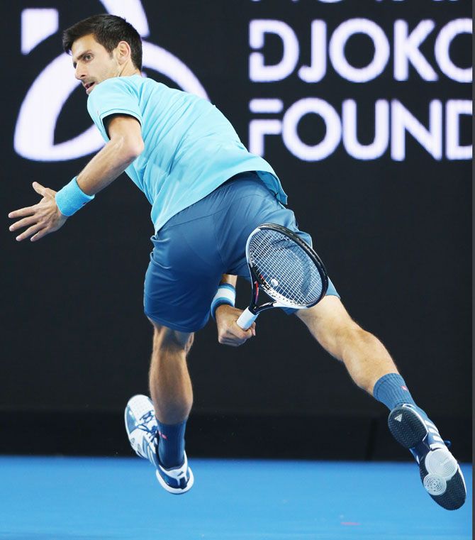 Novak Djokovic hits a forehand through his legs during 'A Night with Novak' at Margaret Court Arena in Melbourne on Wednesday