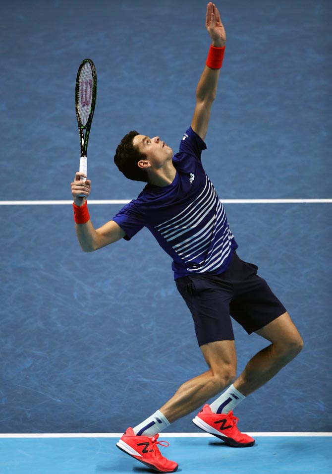 Milos Raonic serves