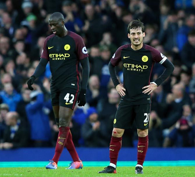  Manchester City teammates Yaya Toure and David Silva look on during a Premier League match