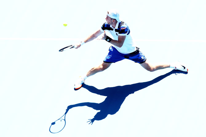 Illya Marchenko plays a backhand in his first round match against Andy Murray