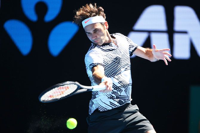 Switzerland's Roger Federer plays a forehand in his second round match against USA's Noah Rubin on day three of the 2017 Australian Open at Melbourne Park on Wednesday