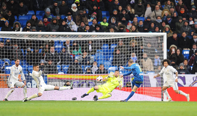 Celta de Vigo's Iago Aspas scores their opening goal against Real Madrid CF during the Copa del Rey quarter-final, first Leg match at the Santiago Bernabeu in Madrid on Wednesday