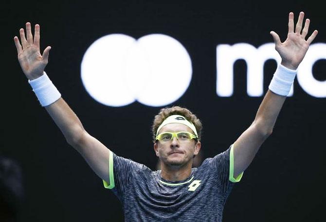 Uzbekistan's Denis Istomin celebrates after winning his second round match against Serbia's Novak Djokovic