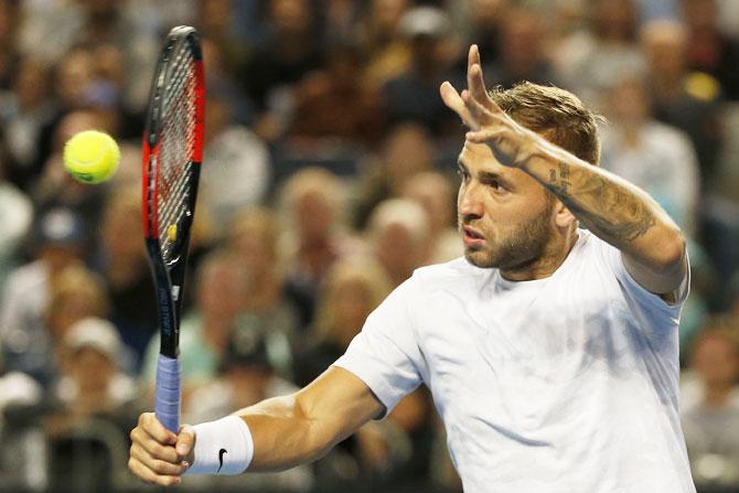 Great Britain's Daniel Evans plays a backhand in his third round match against Australia's Bernard Tomic on Friday