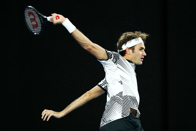 Switzerland's Roger Federer plays a backhand in his third round match against Czech Republic's Thomas Berdych on day five of the 2017 Australian Open at Melbourne Park on Friday