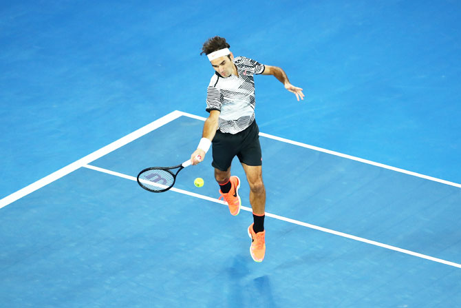 Roger Federer plays a forehand in his third round match against Thomas Berdych