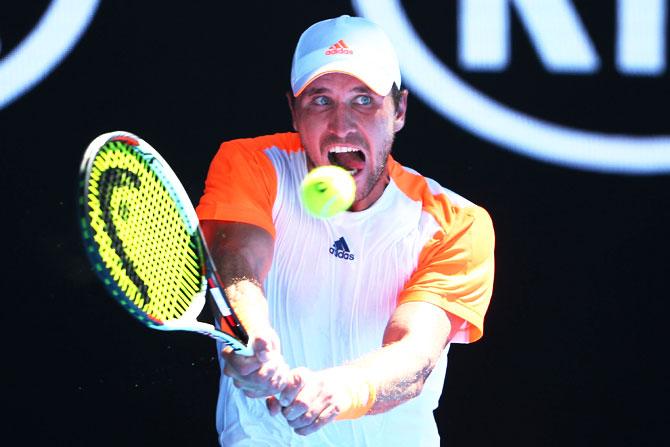 Mischa Zverev of Germany plays a backhand in his fourth round match against Andy Murray of Great Britain on Sunday