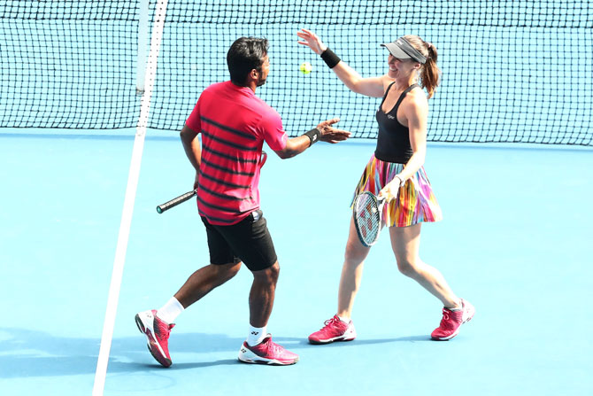 Martina Hingis and Leander Paes celebrate winning their second round mixed-doubles match against Casey Dellacqua and Matt Reid of Australia on day eight of the 2017 Australian Open at Melbourne Park on Monday