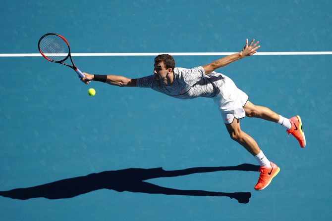 Grigor Dimitrov stretches to play a forehand return in quarter-final match against David Goffin