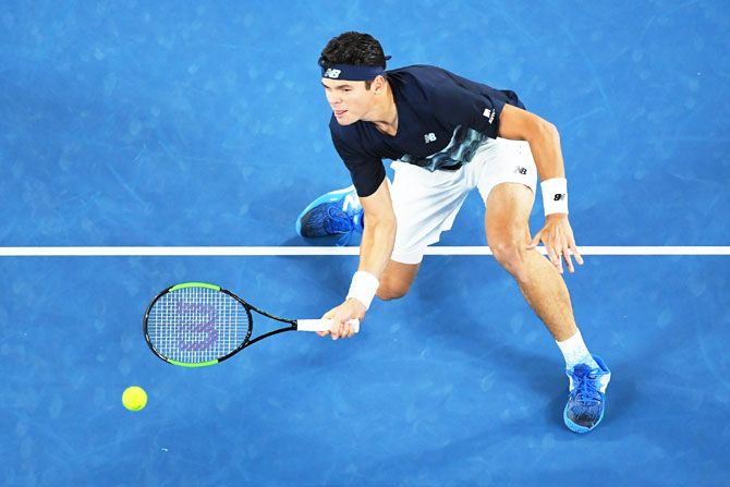 Milos Raonic goes low as he plays a forehand return