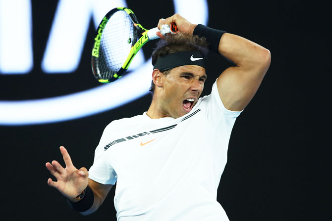 Rafael Nadal plays a forehand return against Milos Raonic