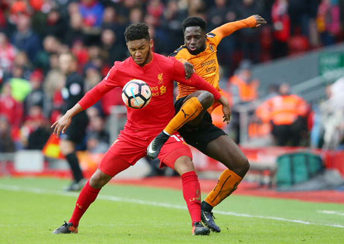 Liverpool's Joe Gomez and Wolverhampton Wanderers' Nouha Dicko vie for possession