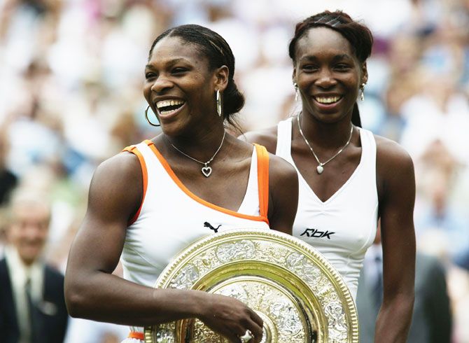 Serena Williams holding the trophy after defeating sister Venus Williams to win the Wimbledon Lawn Tennis Championships at the All England Lawn Tennis and Croquet Club, in Wimbledon, London, on July 5, 2003