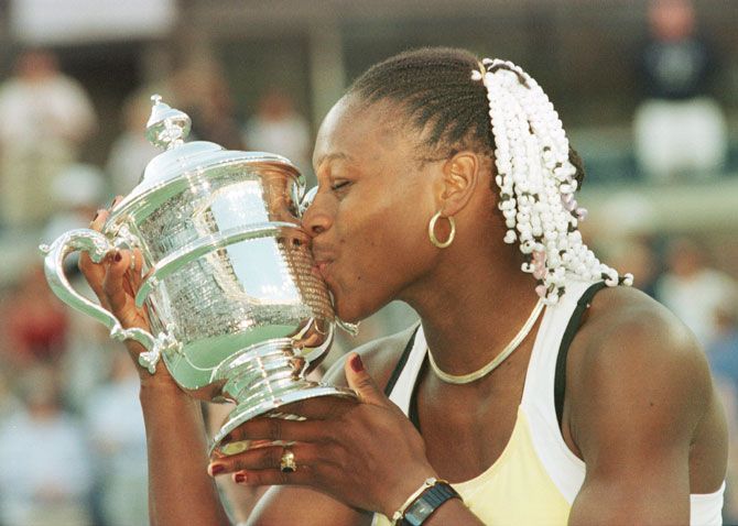Serena Williams kisses the trophy after defeating Martina Hingis to win the US Open at the USTA National Tennis Center in Flushing Meadows, New York, on 11 Sep 1999