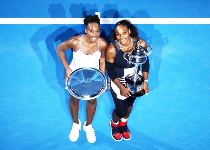 2017 Australian Open champion Serena Williams and Venus Williams poses with the runners-up plate pose for the cameras at Melbourne Park on Saturday