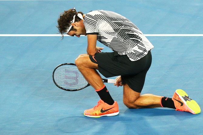 Roger Federer celebrates winning championship point