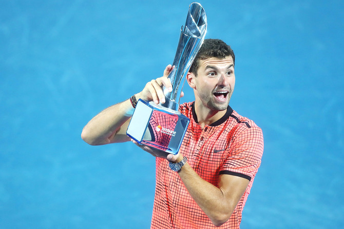 Bulgaria's Grigor Dimitrov holds the Roy Emerson trophy after defeating Japan's Kei Nishikori to win the men's final of the Brisbane international at Pat Rafter Arena in Brisbane, on Sunday