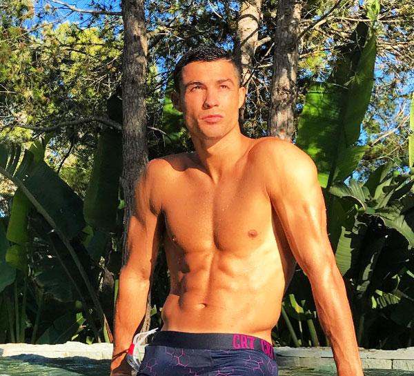 Cristiano Ronaldo poses at a pool