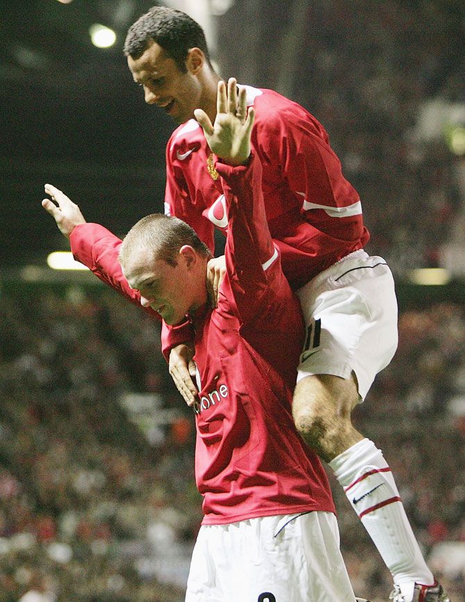 Wayne Rooney of Manchester United celebrates his second goal with teammate Ryan Giggs during the UEFA Champions League Group D match against Fenerbahce SK at Old Trafford on September 28, 2004