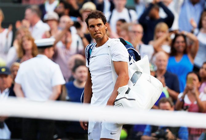 Spain's Rafael Nadal walks off the court after losing to Luxembourg's Gilles Muller in the fourth round of Wimbledon in London on Monday