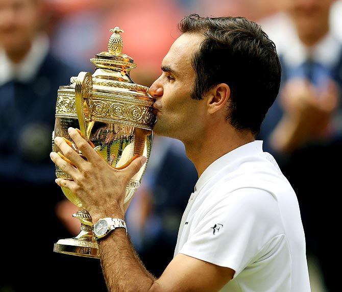 Roger Federer kisses the trophy after winning the 2017 Wimbledon title