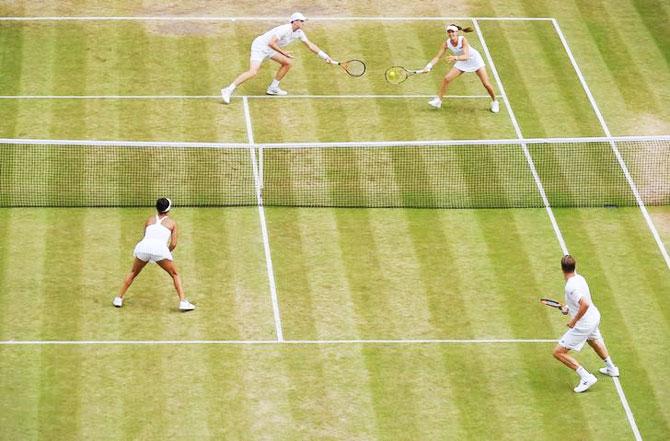 Finland’s Henri Kontinen and Great Britain’s Heather Watson in action during their mixed doubles final against Great Britain’s Jamie Murray and Switzerland’s Martina Hingis