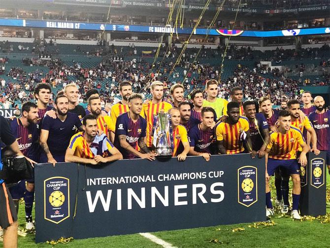 FC Barcelona celebrate with the trophy after defeating Real Madrid in the International Champions Cup competition on Saturday