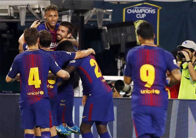 FC Barcelona's Neymar celebrates with teammates after their goal against Real Madrid in their Clasico match in Miami at the International Cup on Saturday