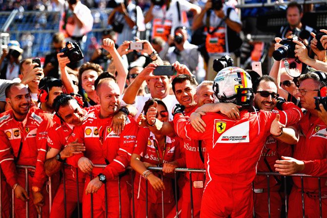 Race winner Sebastian Vettel celebrates his win in parc ferme on Sunday