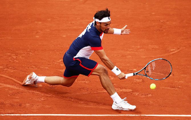Fabio Fognini plays a backhand during his match against Stan Wawrinka