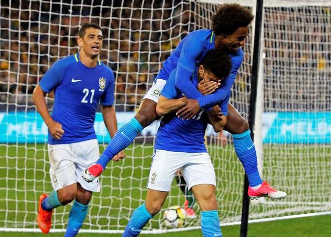 Brazil's Taison celebrates with teammates after scoring the third goal against Australia during their international friendly at Melbourne Cricket Ground on Tuesday